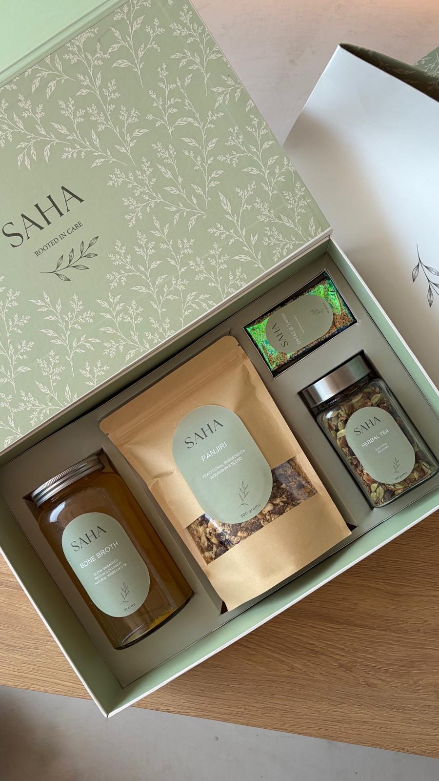 The SAHA Box open, showing bone broth, panjiri, herbal tea and the dates & tahini snack